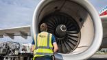 Technician in front of engine